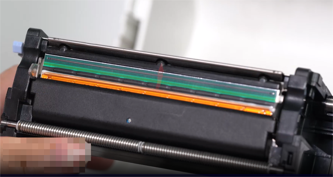 W A close-up of a person carefully cleaning an electronic component with a swab.